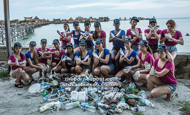 The Miss Scuba International contestants with the rubbish collected from the beach. 