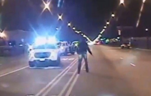 © CHICAGO POLICE/AFP/File / by Mira Oberman | In this screen grab from a video released by the Chicago Police on November 24, 2015, Laquan McDonald (R) walks past police cars carrying a knife, before being shot, in Chicago, Illinois on October 24, 2014