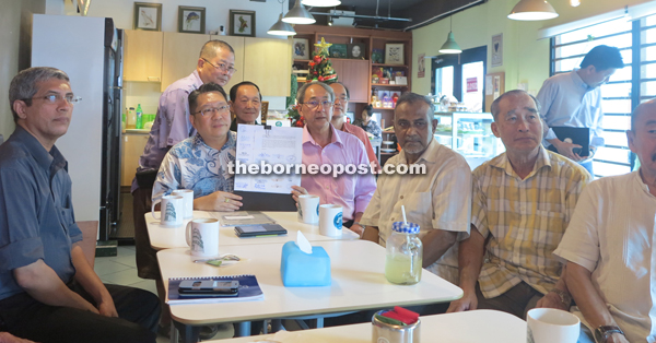 Wee (second left) with other India Street tenants and business owners holding up the letter to be submitted to DBKU.