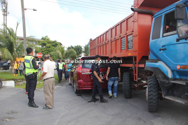 Police personnel gather evidence at the scene.