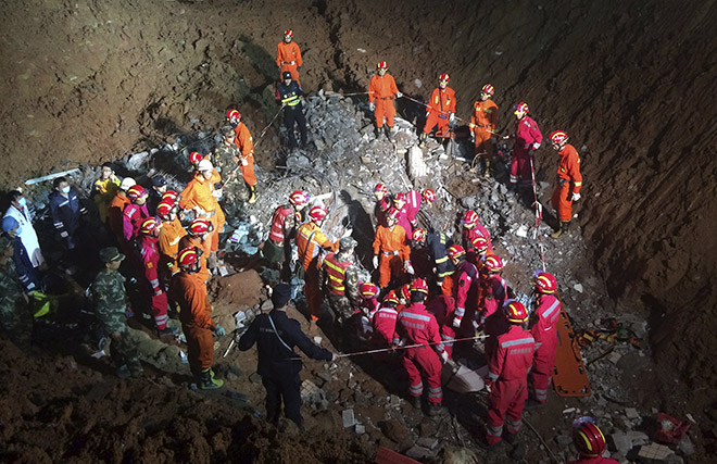 Rescuers surround the area where they found a 19-year-old survivor under a collapsed building at the site of a landslide which hit an industrial park on Sunday, in Shenzhen, Guangdong. — Reuters photo
