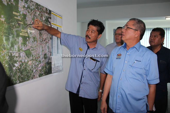 Tan (left) briefs Fadillah on the progress of the project.