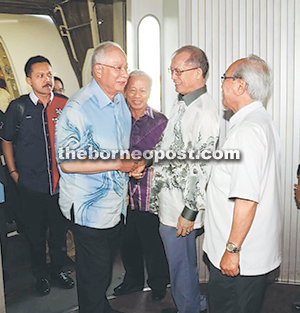 Najib is greeted by Human Resources Minister Datuk Seri Richard Riot as he alights from the aircraft into the aerobridge while Jabu, Tan Sri Datuk Amar Dr James Masing and others look on. — Photo by Jeffery Mostapa