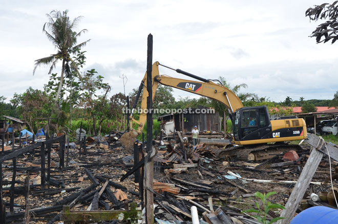 The site of the razed longhouse being cleared.