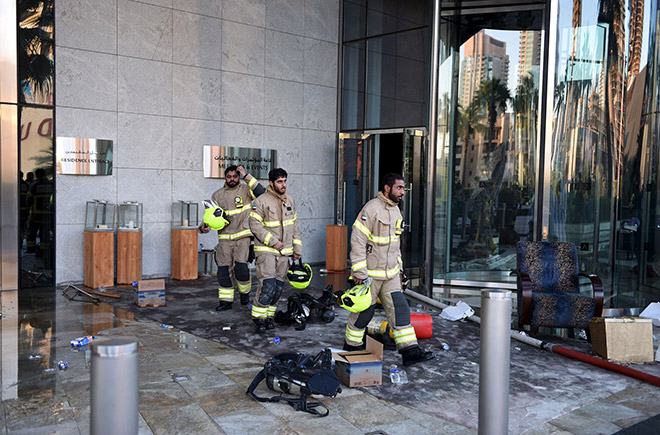 Firefighters walk at Address Downtown Dubai hotel and residential block, which was hit by a blaze during New Year celebrations, in Dubai. — Reuters photo