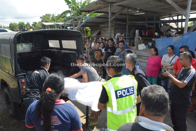 Police place Gala’s body into a vehicle for transportation to Miri Hospital.