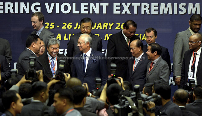 Najib (front, centre) having a light moment with delegates. On his right is his deputy Datuk Seri Dr Ahmad Zahid Hamidi. — Bernama photo