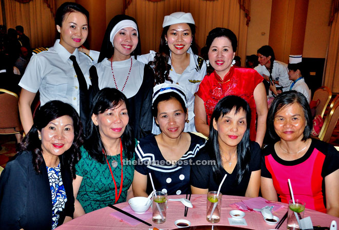 Women guests in various costumes smile for the camera. — Photos by Othman Ishak