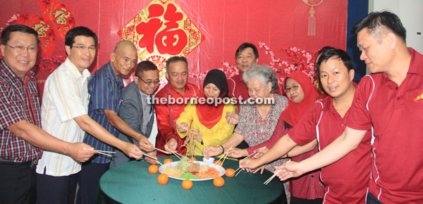 (From fifth left) Antonio, Sabariah and other guests toss ‘Yee Sang’ at the gathering.