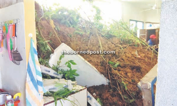 Damages caused by a landslide following continuous rain at Kampung Pichin resident Henry Silam’s house in Serian.