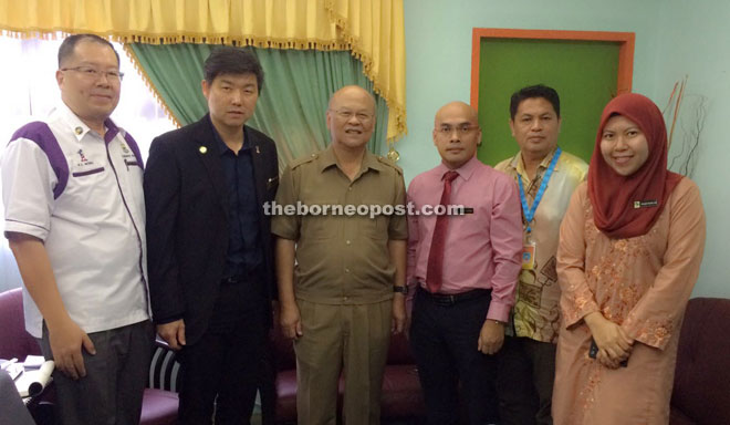 Minos (third left) in his office with senior personnel from SDC and Fama.