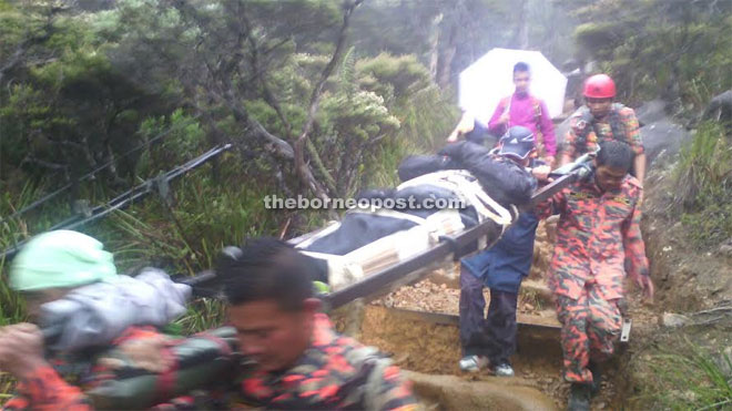 Mosar team carrying the victim down Mount Kinabalu on Tuesday evening.