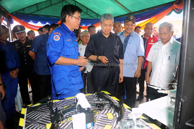 Ahmad Zahid looking at equipment used by Civil Defence Department for search and rescue operations. Looking on are Masing (right) and Shahidan (second right). — Bernama photo