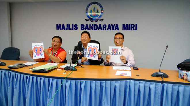 Lai (centre) shows the Miri May Fest logo. He is flanked by Miri City Day celebration organising chairman councillor Ernest Goh (left) and councillor Kok Yung Kai. 