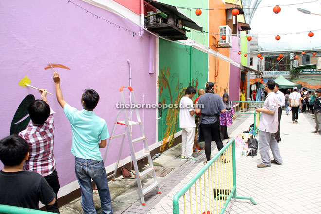 Some members of the public take the opportunity to join in the fun at Kai Joo Lane.  