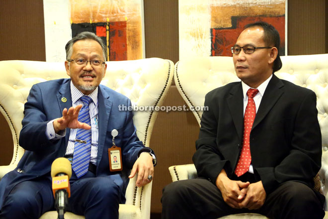 Sapuan (left) speaking to reporters after officiating at the workshop while Dr Ahmad looks on. — Photo by Muhammad Rais Sanusi