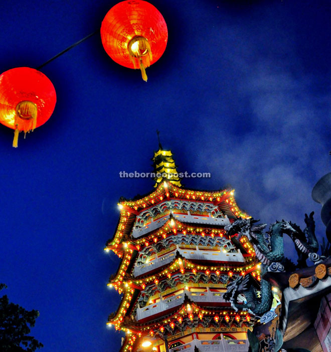 Two red lanterns stand out in front of the pagoda.