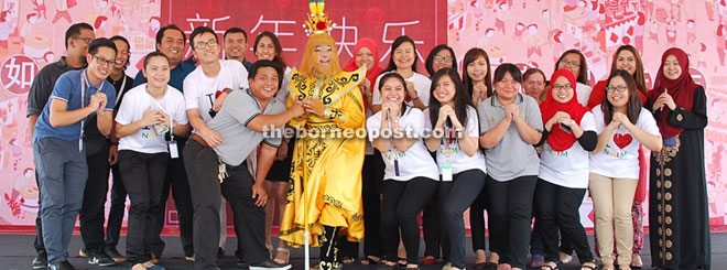 Naim staff and the Monkey God wishing the people prosperity in the Year of the Monkey.