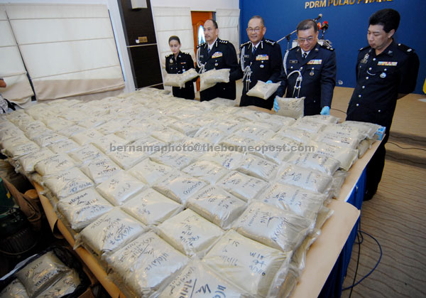 Abdul Ghafar (centre) and his officers show ketum powder seized during an operation during a press conference at the Penang police contingent headquarters. — Bernama photo