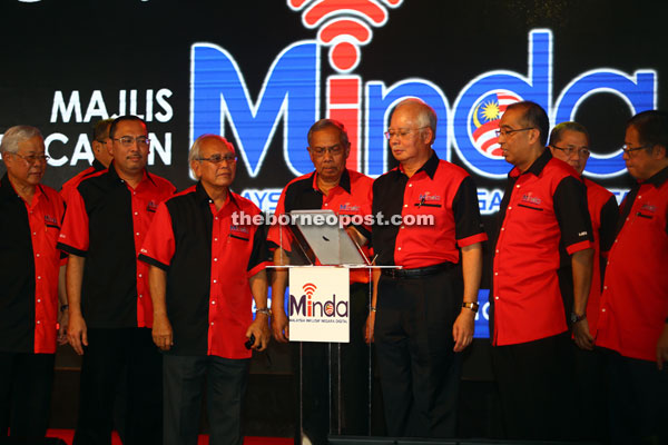 Najib (fifth left) launches Minda as Chief Minister Datuk Patinggi Tan Sri Adenan Satem (fourth left) and other federal and state leaders look on.  — Photos by Muhd Rais Sanusi
