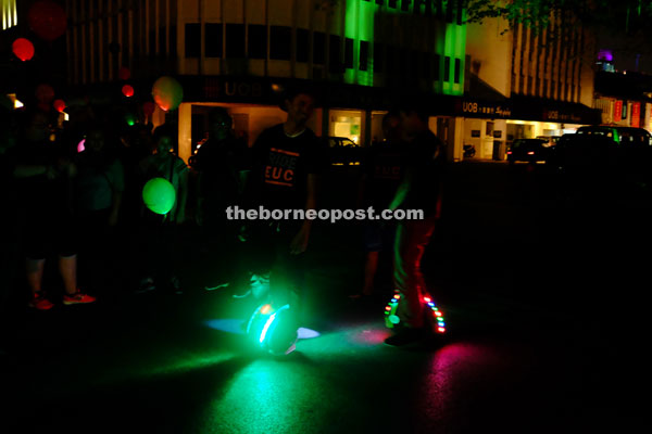 Enthusiasts riding electric unicycles take advantage of the clear roads to have a little fun in the dark with their illuminated gadgets. 
