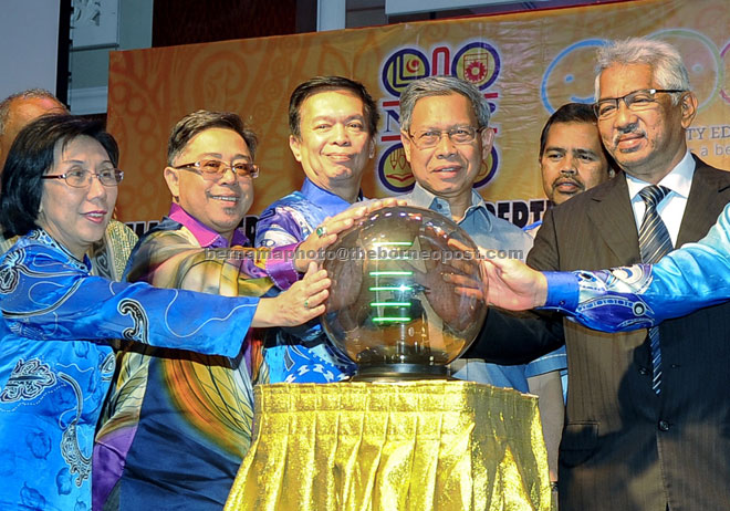 Mustapha (third right) touches the crystal ball to symbolically officiat  the mid-term review of the National Union of the Teaching Profession (NUTP) 2014-2017. Hashim Adnan is at third left. — Berna ma photo