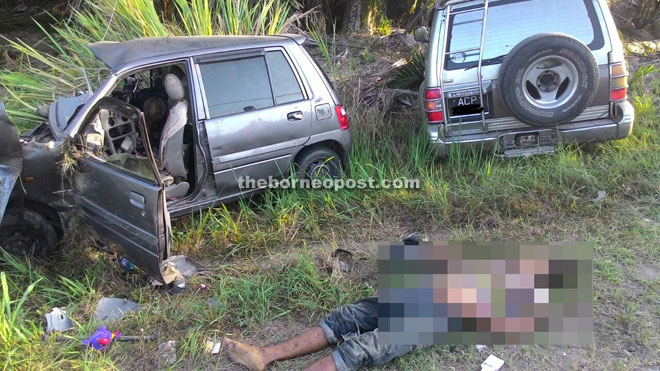 The body of the Perodua Kancil driver at the scene of the accident at Km 15, Semporna-Tawau road.