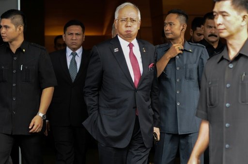 AFP/File | Malaysia's Prime Minister Najib Razak (C) reacts as he walks towards his car after attending a parliament session in Kuala Lumpur on January 26, 2016 