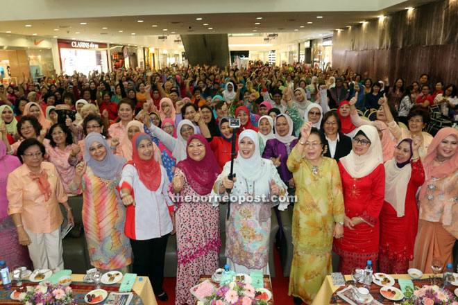 Jamilah (front row, centre) takes a wefie with attendees at the celebration. From front fourth left are Rohani, Empiang, Fatimah and Rosey. — Photo by Jeffery Mostapa