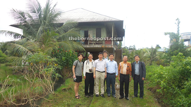 Representatives of Chung Dong First Methodist Church and Wong (second left) in front of the house where Soung Wook and his family once lived.