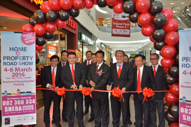 Abdul Karim (third left), Joseph (left), Dr. Ngui (second left), Alan (third right) and Sim (second right) preparing to cut the ribbon as a symbolic sign to mark the opening of the property roadshow at Boulevard Shopping Mall here yesterday. — Photo by Chang Lee Fong 