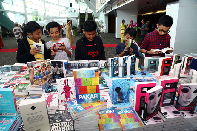 Students browsing titles at the Sarawak Book Expo at BCCK yesterday. - Photo by Muhd Rais Sanusi