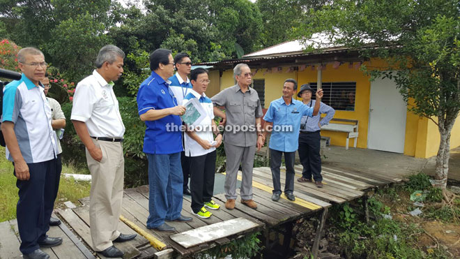 Wan Junaidi (third right) and his entourage at a village in Sri Aman. 