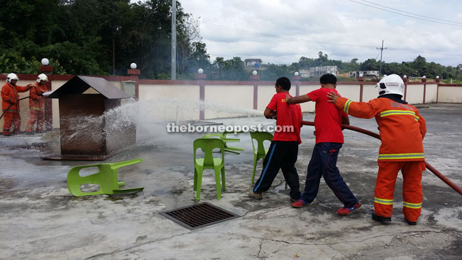 Members of the Bomba Community try to put out a fire in this demonstration. 