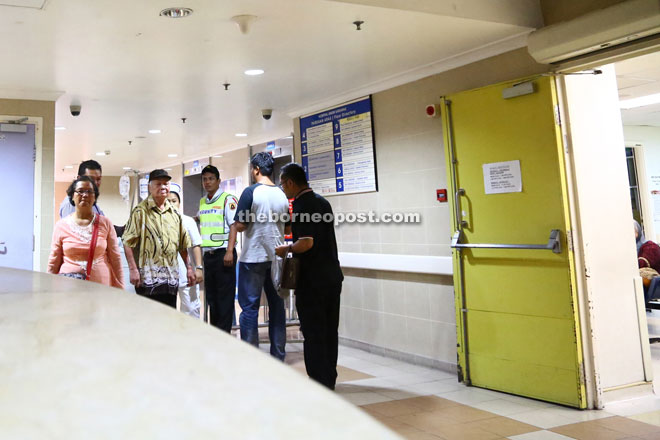 Visitors and staff walk through the hospital's lift lobby. 