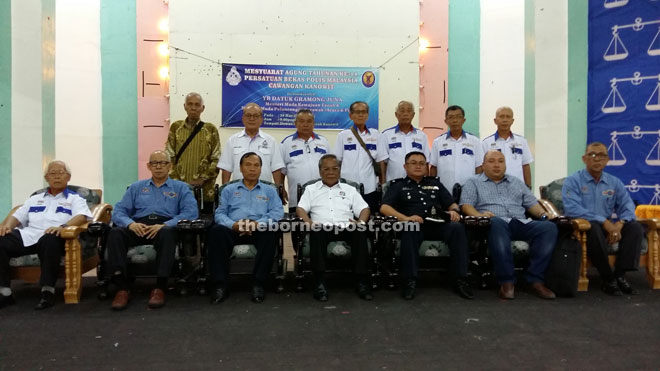 Gramong (seated, centre) and executive members of PBPM Kanowit pose for a photo. From third left are Liew, Daniel and Allan.