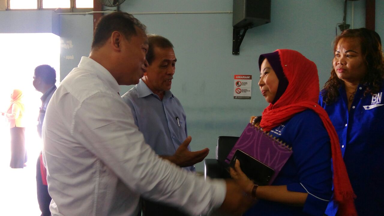 BN candidate Rosey Yunus (right) and independent candidate Austin Sigi greeting one another after submitting their nomination papers at Bekenu nomination centre. Both are former SPDP members.