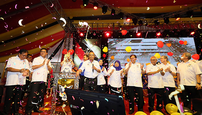 The stage bursting with colourful confetti and balloons as Adenan (third left) sings a few songs while several senior ministers cheer and clap along.