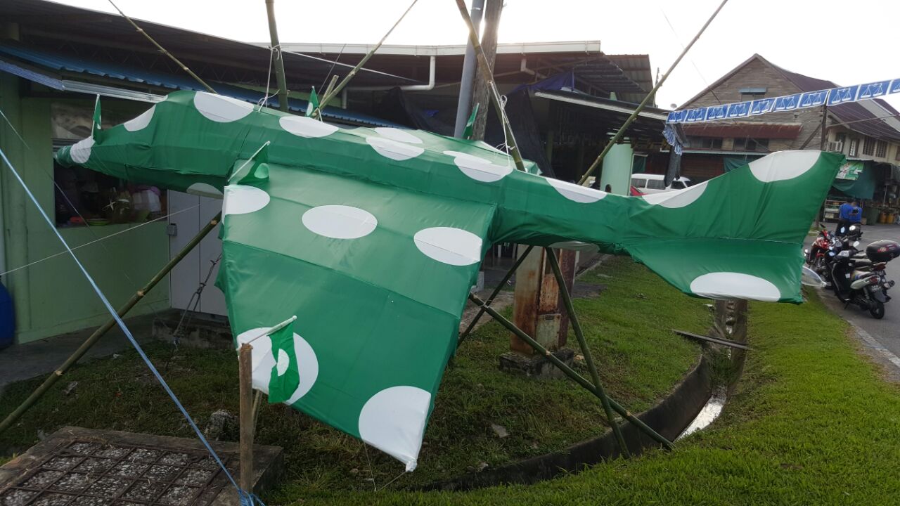 CREATIVITY: An airplane model wrapped out by PAS flag were seen decorated near the N24 Sadong Jaya nomination centre.