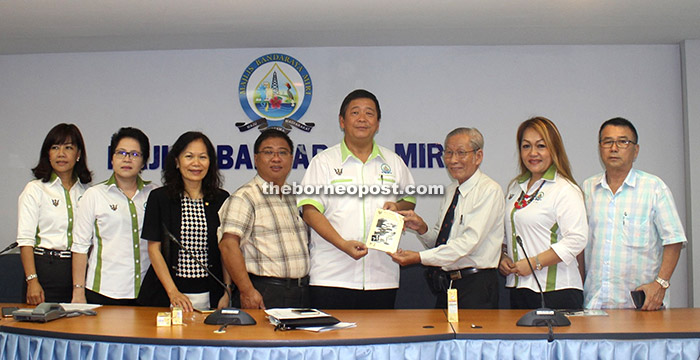 Awang Tengah (fifth right), flanked by Naroden on his right and Asfia, hands over a mock cheque for RM50,000 to a representative of Kumpulan Wang Amanah Pembangunan (KWAP) of the Cooperatives Commission of Malaysia after the opening ceremony.