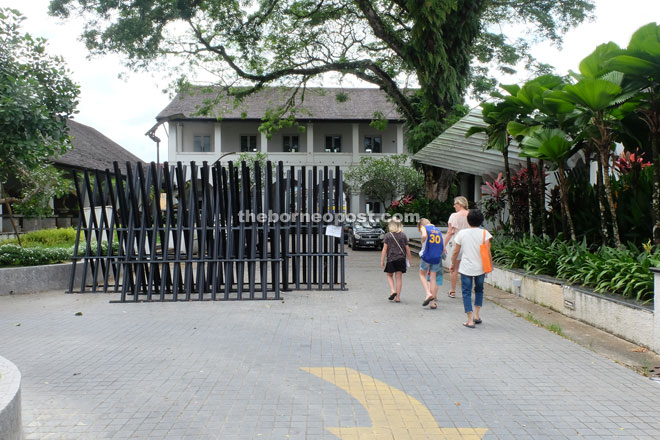 Visitors walk past the barricades, which were used to block the walkway last week.