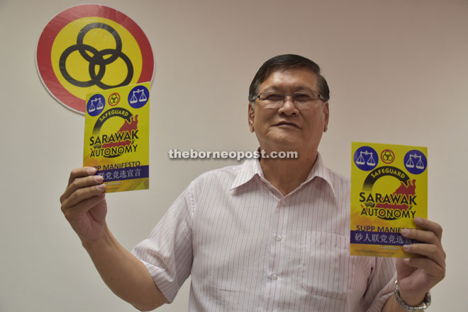 Chen shows the SUPP Manifesto booklet which will be released after Nomination Day. 