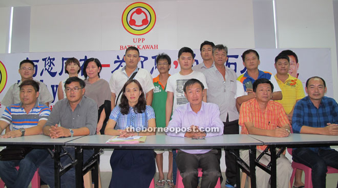 Christine (seated third left) with (seated from second left) Lim Fatt, Chong and others in a photo call after the news conference.