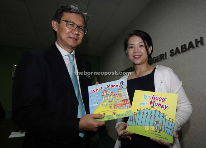 Liv handing over her books to Wong at the State Library yesterday. 