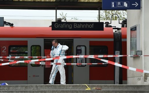 A forensic expert collects evidence following the knife attack at Grafing train station in southern Germany, on May 10, 2016 