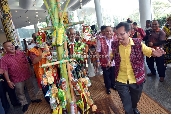 Dr Sim (right) does the Ngajat during the launch of the Pre-Gawai celebration together with MBKS mayor Datuk James Chan (behind Dr Sim) and others. — Photo by Tan Song Wei