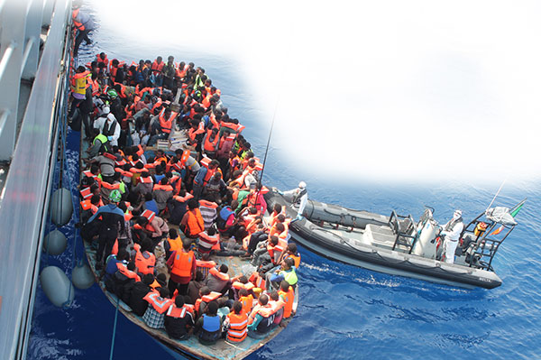 Migrants are rescued from an overloaded boat. 