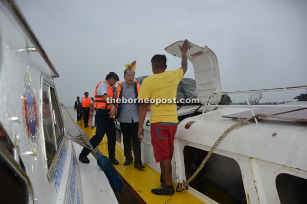 Jinep inspects an express boat during the river block at Rajang River. 