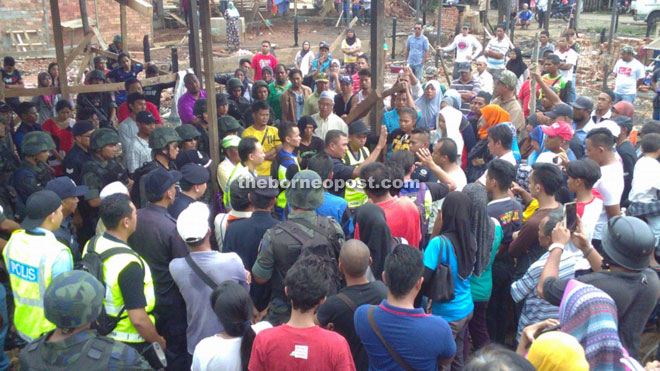 Fadil (centre) calming the affected residents when the situation became tense.