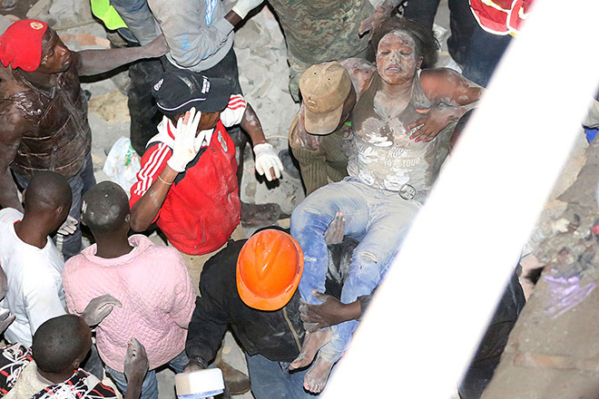 Emergency personnel rescue a woman from a collapsed building in Nairobi. — AFP photo